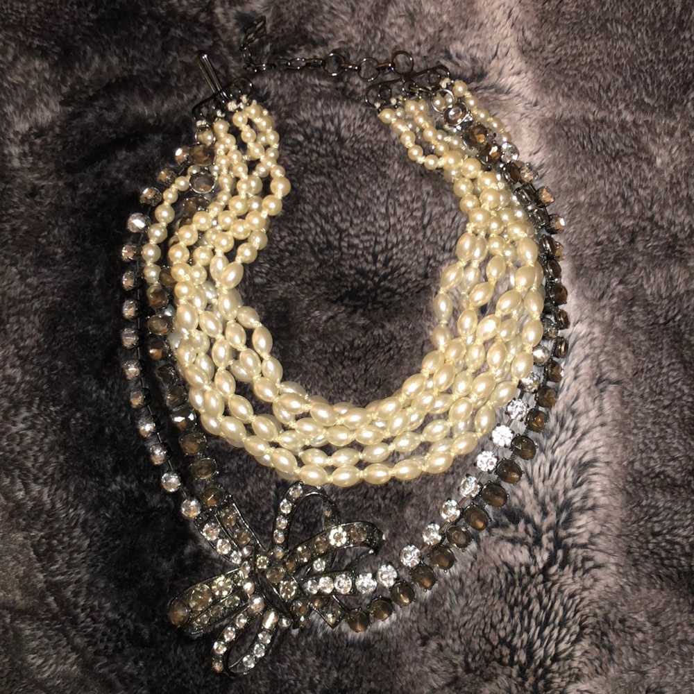 BCBG costume jewelry faux pearl and a disconnected dragonfly that comes off.